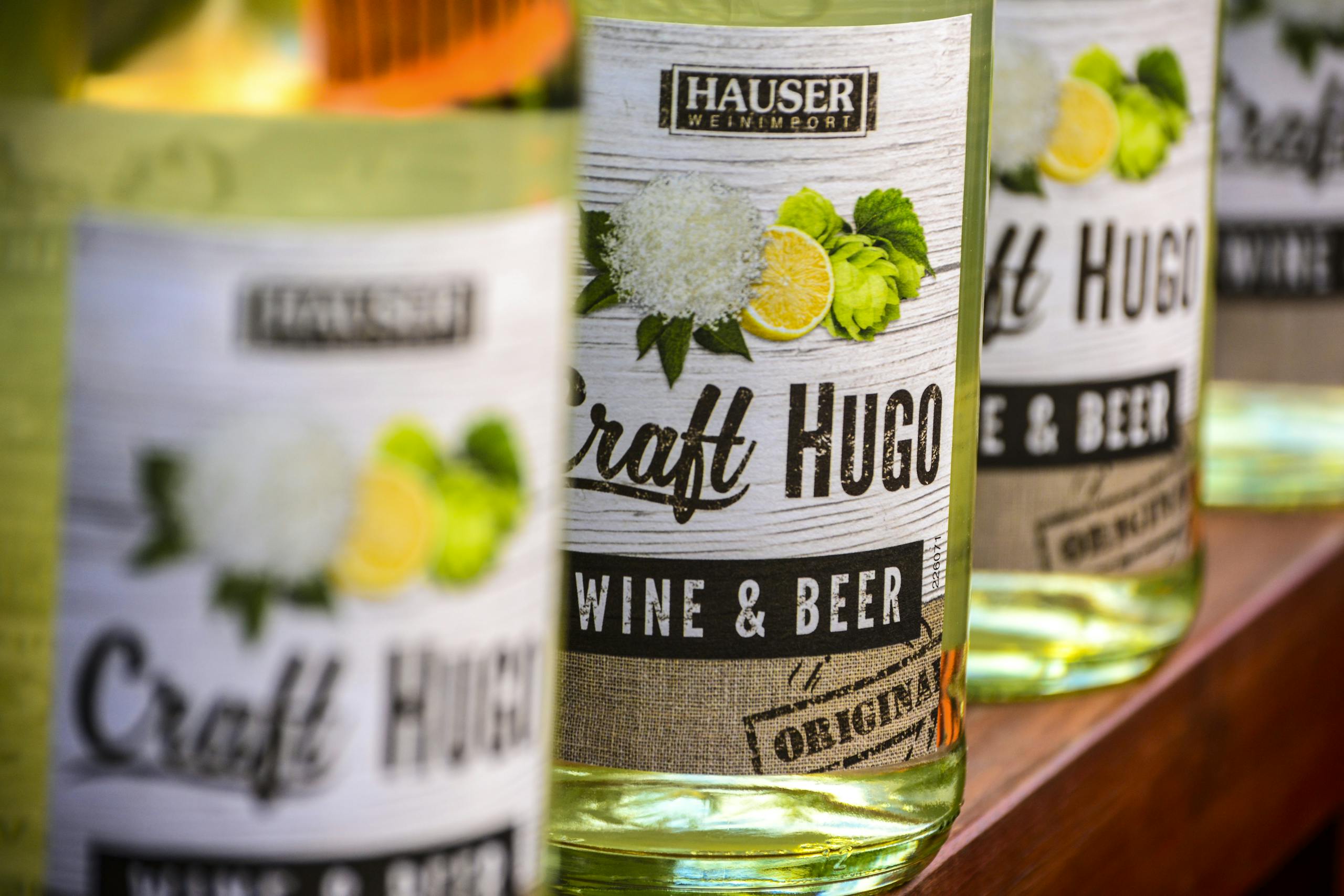 Detailed view of Craft Hugo wine and beer bottles highlighting branding and labels.